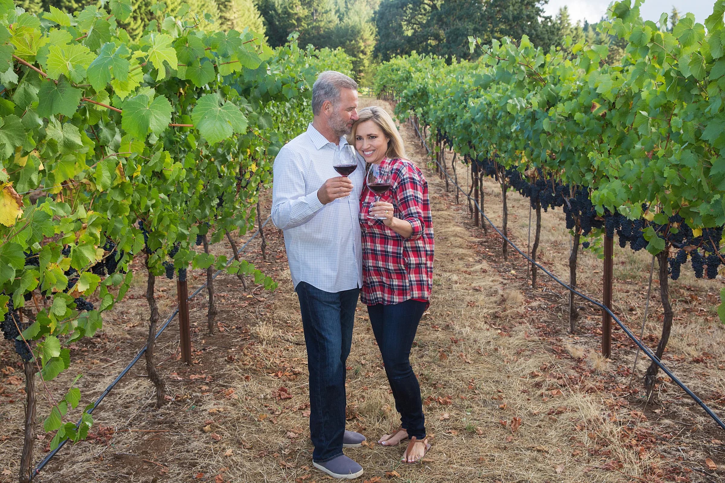Couple enjoying a romantic wine country date through the Willamette Valley with Hidden Vineyards Wine Tours